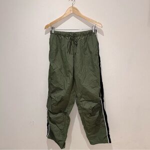 No Vacancy Inn green track pants with white and black stripes